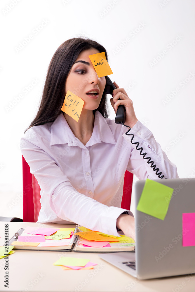Young female employee in conflicting priorities concept Young female employee in conflicting priorities concept