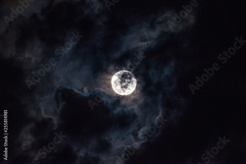 Moon through the clouds at night, super moon