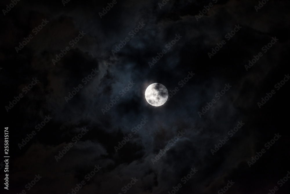 Moon through the clouds at night, super moon Moon through the clouds at night, super moon