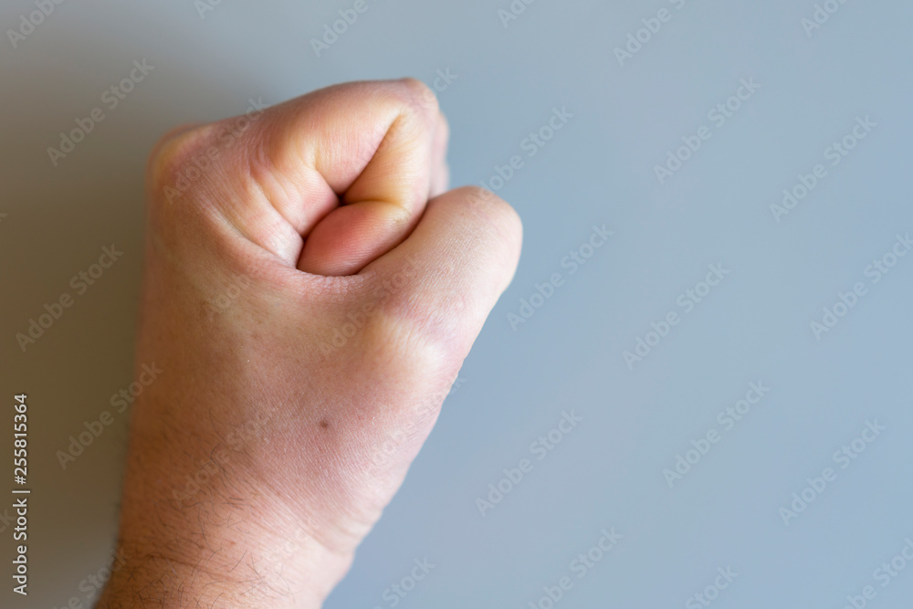 fist on gray background. The concept of domestic violence. Male rudeness and violence. copy space fist on gray background. The concept of domestic violence. Male rudeness and violence. copy space