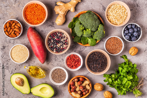 Superfoods on gray concrete background. Top view.