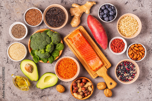 Superfoods on gray concrete background. Top view.