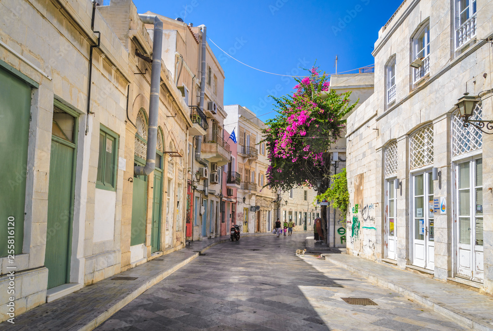 Sidewalk with traditional neoclassical buildings in Ermoupoli in Syros island capital of Cyclades Greece