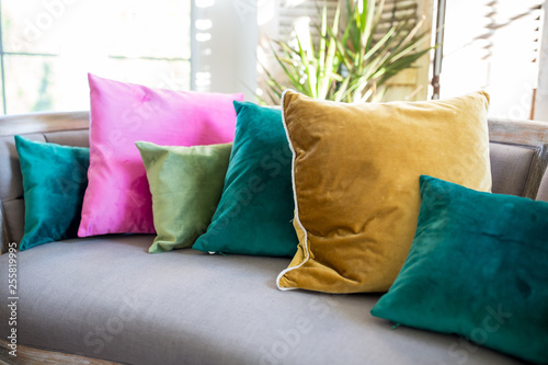 Couch with assorted jewel tone pillows