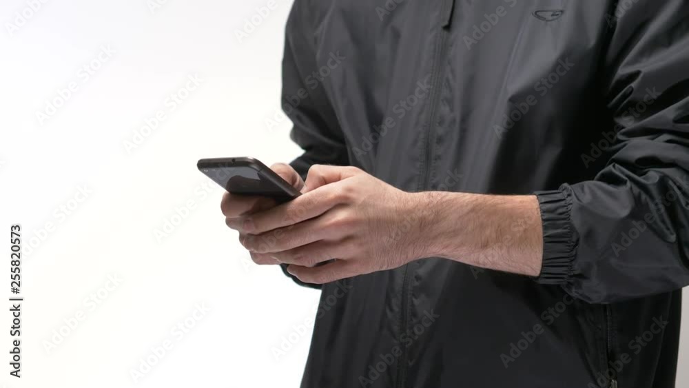 Millennial men using a smartphone in front of a white background. Millennial men using a smartphone in front of a white background.