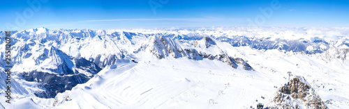 Panoramic landscape Winter view from the top of Kitzsteinhorn mountain on snow covered slopes, blue sky. Kaprun ski resort, National Park Hohe Tauern, Austrian Alps, Europe.