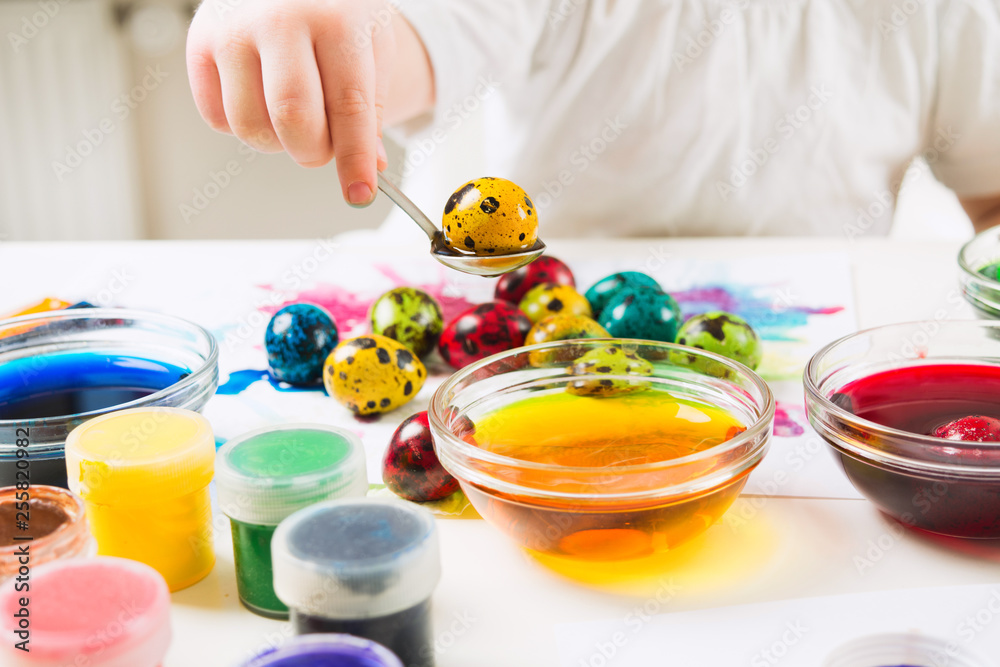 Child pulled yellow quail egg from paint Child pulled yellow quail egg from paint