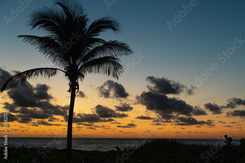 Sunrise on Delray Beach with clouds and calm water in late winter. © Carol A Hudson