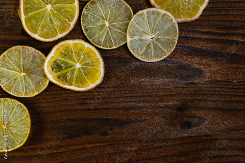 sliced dried lemons and limes on a wooden Board