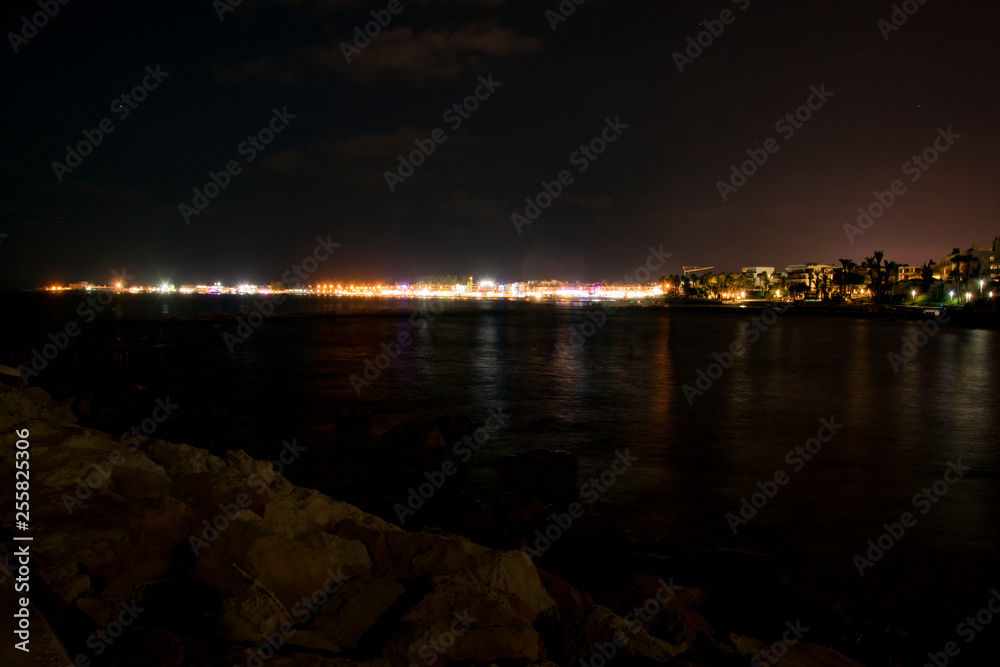 Cyprus, Paphos, night city panorama lights, coastline and sea Cyprus, Paphos, night city panorama lights, coastline and sea