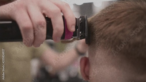  Men's haircut in barbershop. Male hair care. Video is a vintage noise filter. An old filter. photo