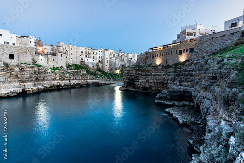 Polignano a Mare  Puglia - Italy. Sunset at Cala Paura gulf with Bastione di Santo Stefano and Lama Monachile beach on background