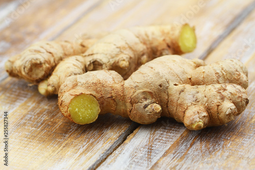 Fresh ginger root on wooden surface