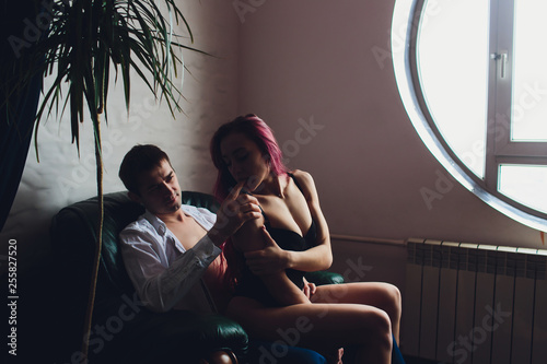 Canvas Print attractive young brunette girl sucks her boyfriend's finger with her mouth lips