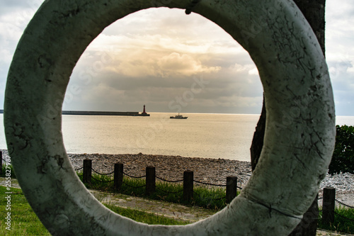 Ocean Graphic - Life preserver with ship off in the distance photo
