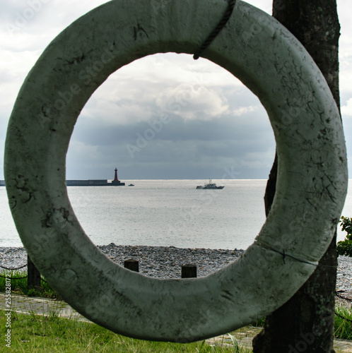 Ocean Graphic - Life preserver with ship off in the distance photo