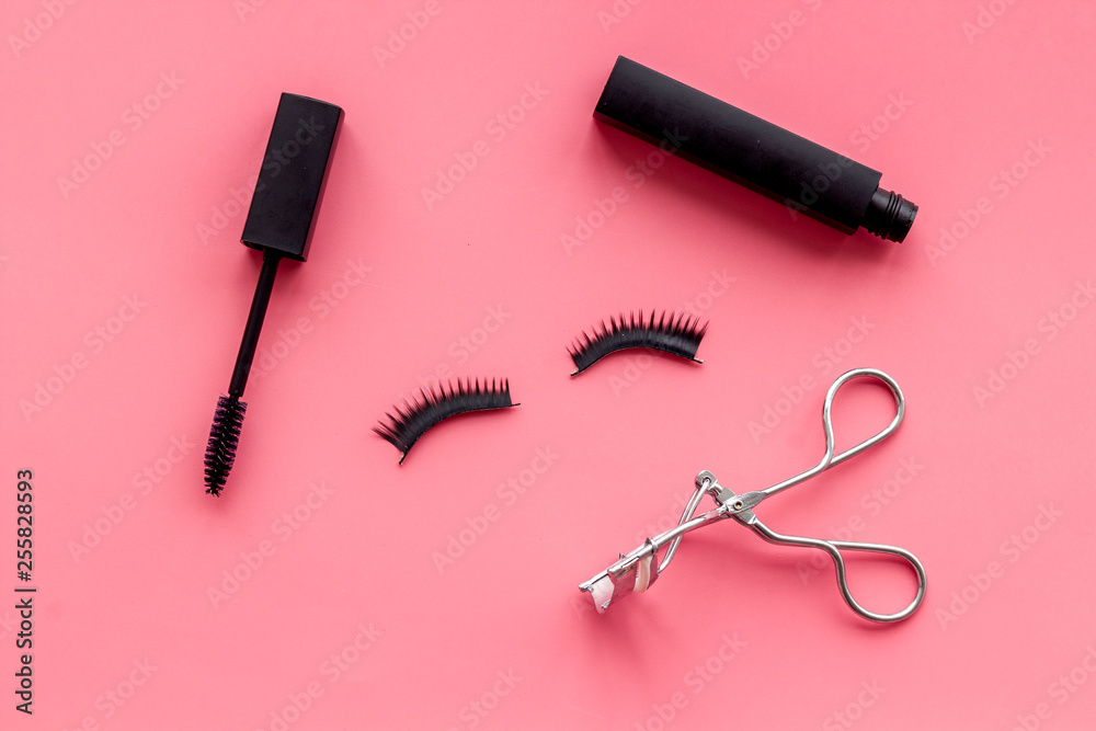 decorative cosmetic set with lash curler and mascara on pink woman desk background top view decorative cosmetic set with lash curler and mascara on pink woman desk background top view