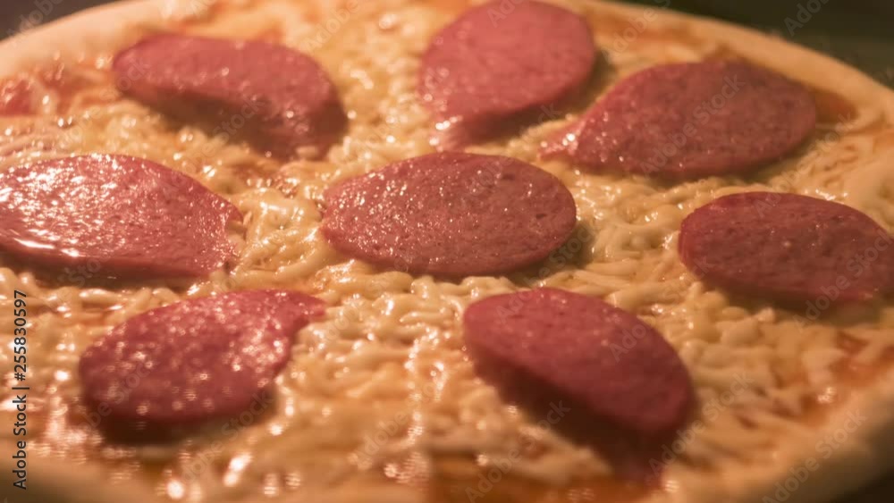 Pizza with cheese salami and tomato paste cooking in the oven time-lapse. Pizza with cheese salami and tomato paste cooking in the oven time-lapse.
