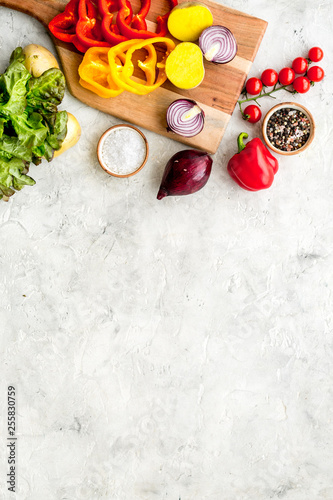 Fresh food ingredients for vegetarian kitchen on white stone background top view mock-up