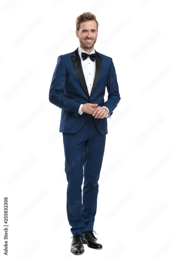 sexy smiling man in blue suit holding his hands together Stock Photo ...