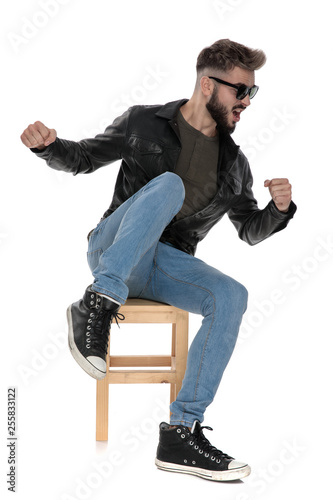 man kicking with his leg while looking away