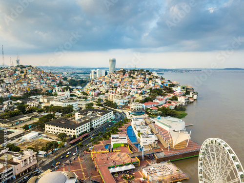 Aerial view of Guayaquil city, where the ferris wheel La Perla is located and Las Penas is in the background. A recreational and touristic place in the city.