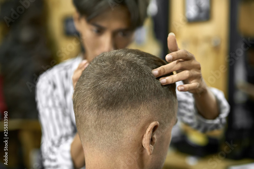 Man is cutting his hair in asian barbershop