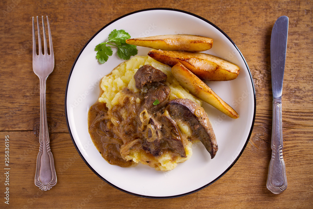Liver with pears and cream and wine onion sause on mashed potato. overhead, horizontal Liver with pears and cream and wine onion sause on mashed potato. overhead, horizontal