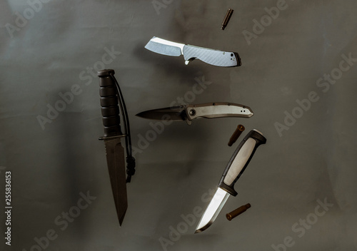 Flying knives and bullets. A few knives. Knives in the air. photo