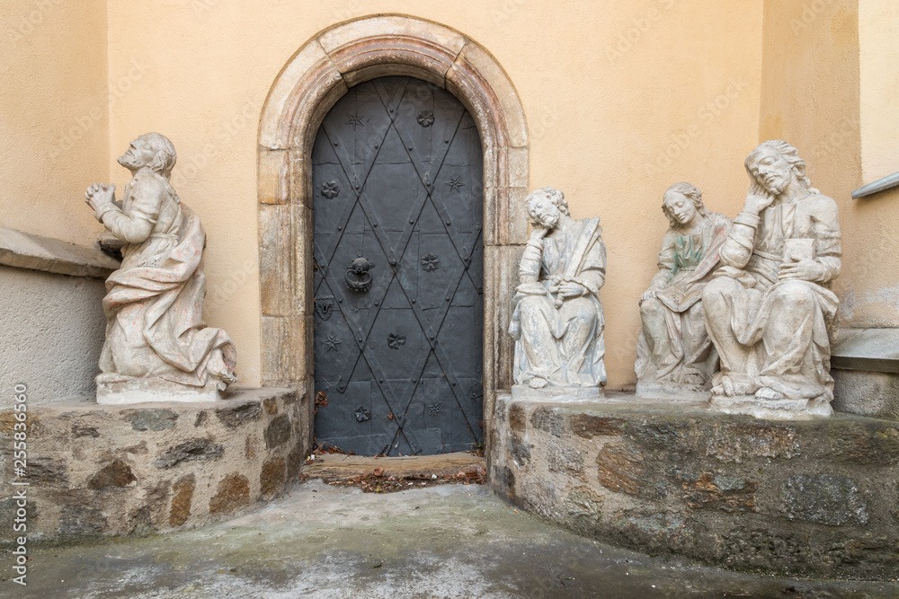 Baroque statues of saints at entry to St. Mark's Church in Wolfsberg in Austria