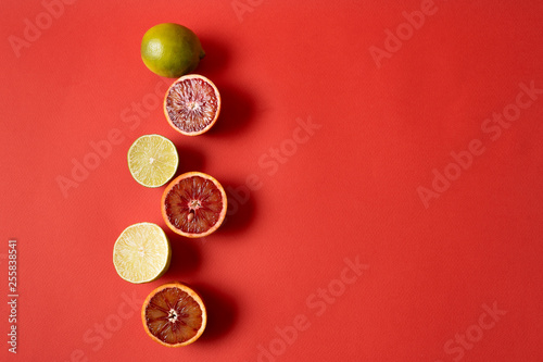 Flat lay the raw fresh lemon and orange citrus fruit over red background.