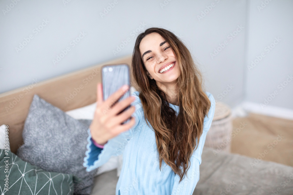 © BestForYou - Pretty smiling woman taking selfie using smartphone at home. © BestForYou - Pretty smiling woman taking selfie using smartphone at home.