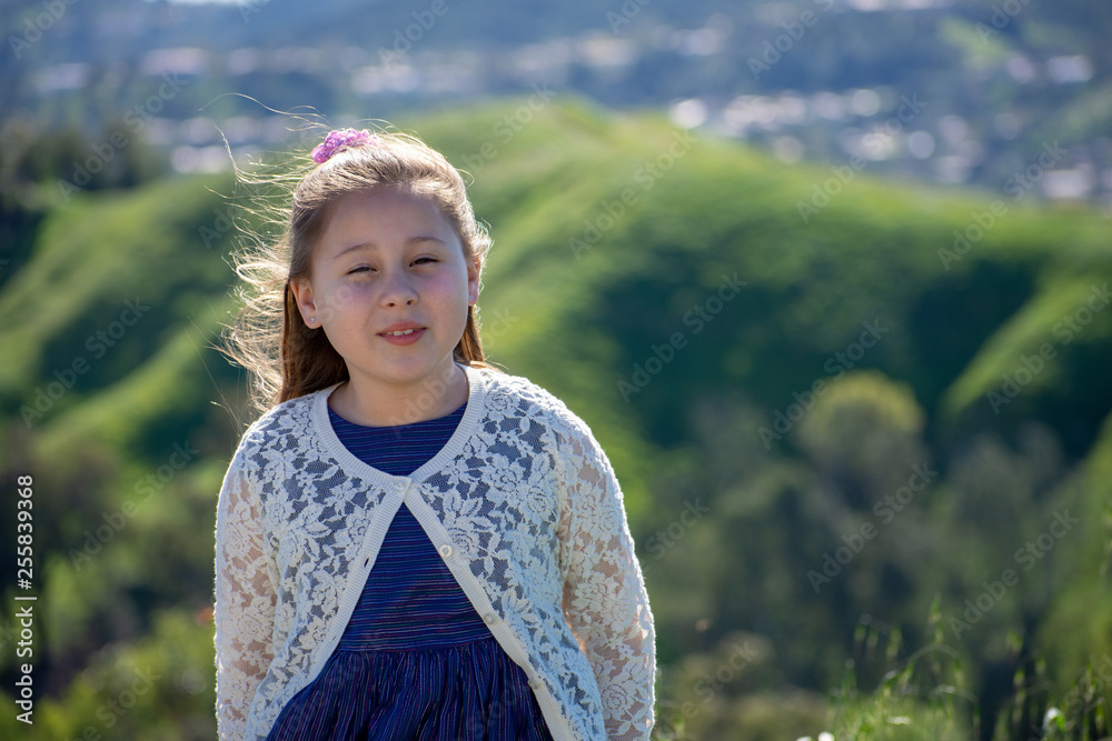Smiling Little Girl with Green Hill Countryside Background Smiling Little Girl with Green Hill Countryside Background