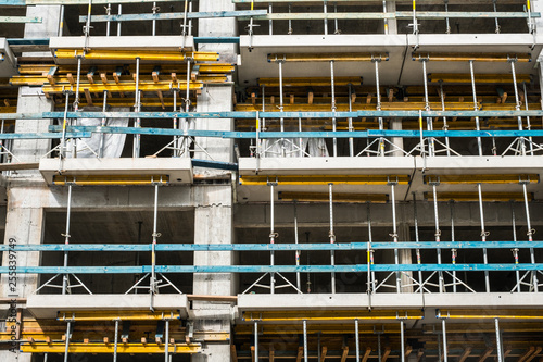 scaffolding on  house facade, apartment building under construction -