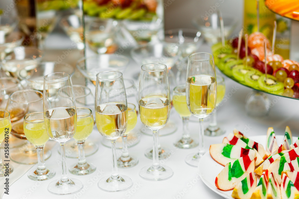 Champagne glasses. Delicious sweet buffet with cupcakes sparkling wine in party.