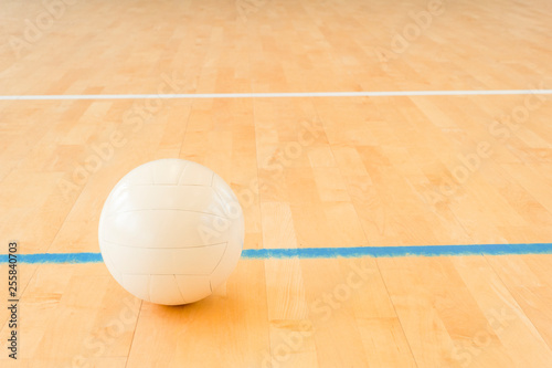 White volleyball on the floor in the gym
