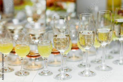 Champagne glasses. Delicious sweet buffet with cupcakes sparkling wine in party.