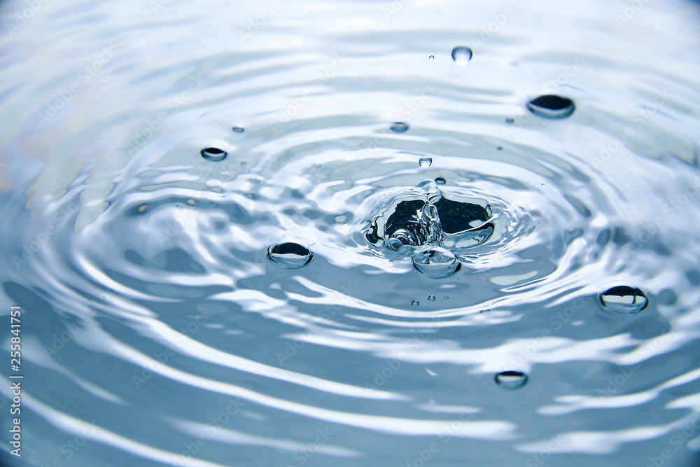 close up of drop in water making different splashes close up of drop in water making different splashes