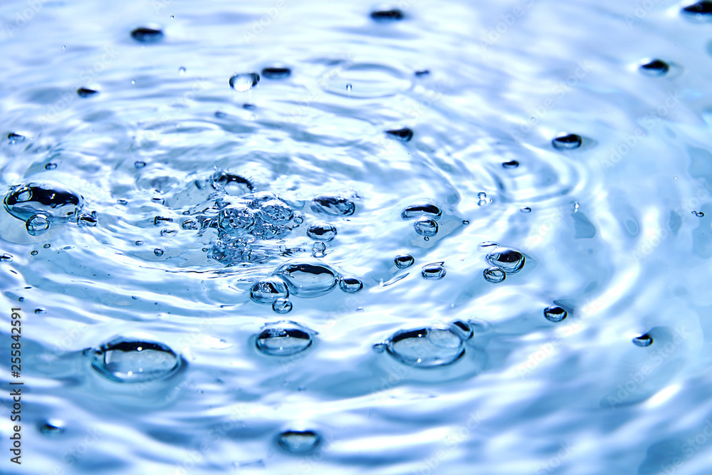 close up of drop in water making different splashes close up of drop in water making different splashes
