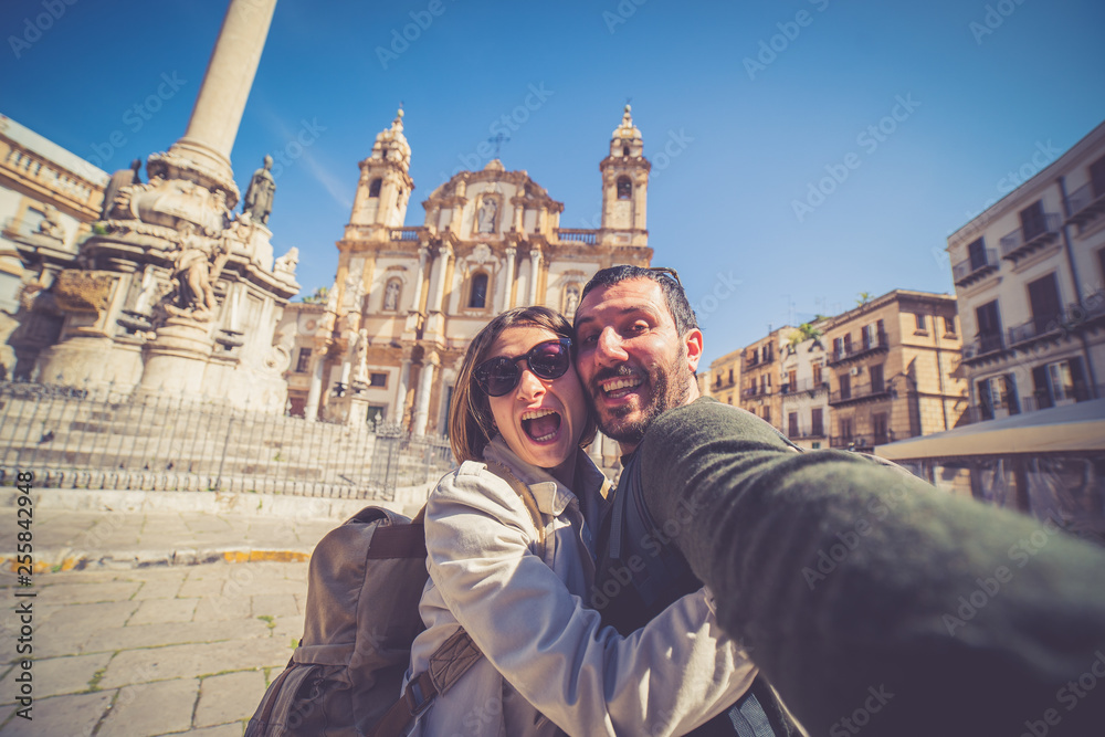 happy tourist couple taking selfie in Palermo in the San Domenico church in Palermo square, Sicily, Italy