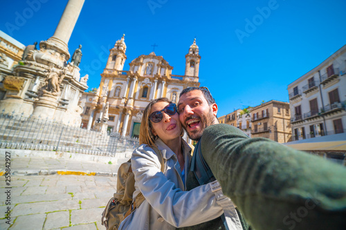 happy tourist couple taking selfie in Palermo in the San Domenico church in Palermo square, Sicily, Italy