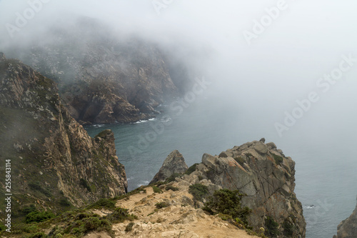 Cape Roca (Cabo da Roca) cliffs in fog. The rocks are obscured by clouds or fog. Cape Roca is most western part of Europe, Portugal.