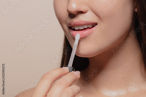 Applying transparent lip gloss