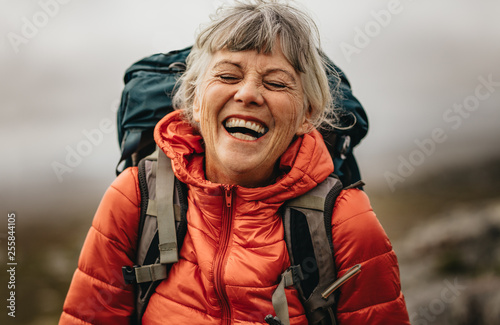 Fototapeta Senior woman enjoying her hiking trip