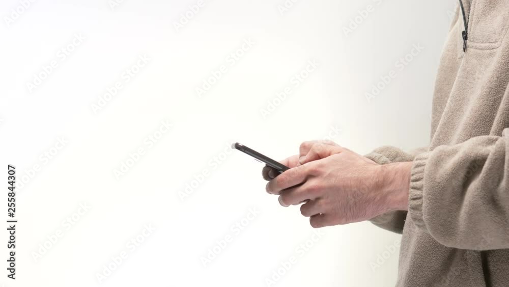 Millennial men using a smartphone in front of a white background. Millennial men using a smartphone in front of a white background.