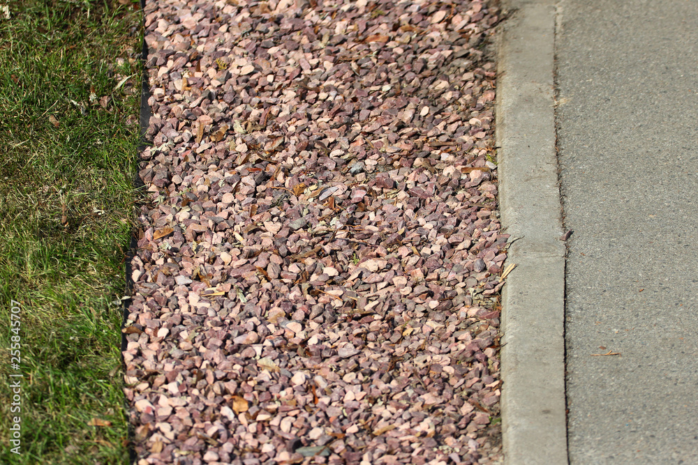 Gravel belt between lawn and sidewalk in a park Gravel belt between lawn and sidewalk in a park
