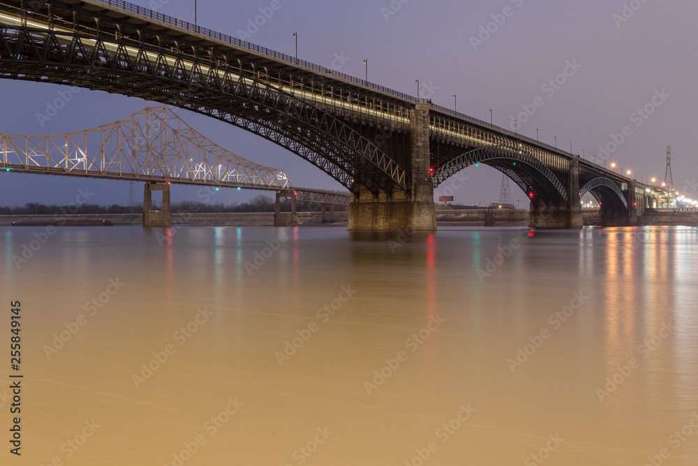 Large steel bridge crossing the mighty Mississippi River in urban St. Louis