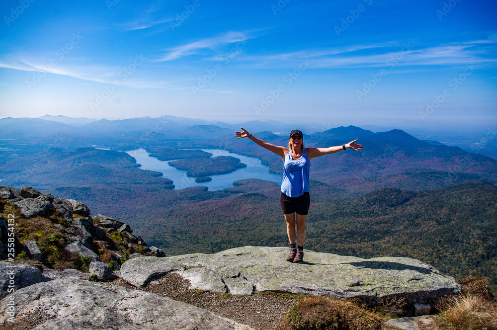 Female hiker with her arms out at the summit of Whiteface Mountain Female hiker with her arms out at the summit of Whiteface Mountain