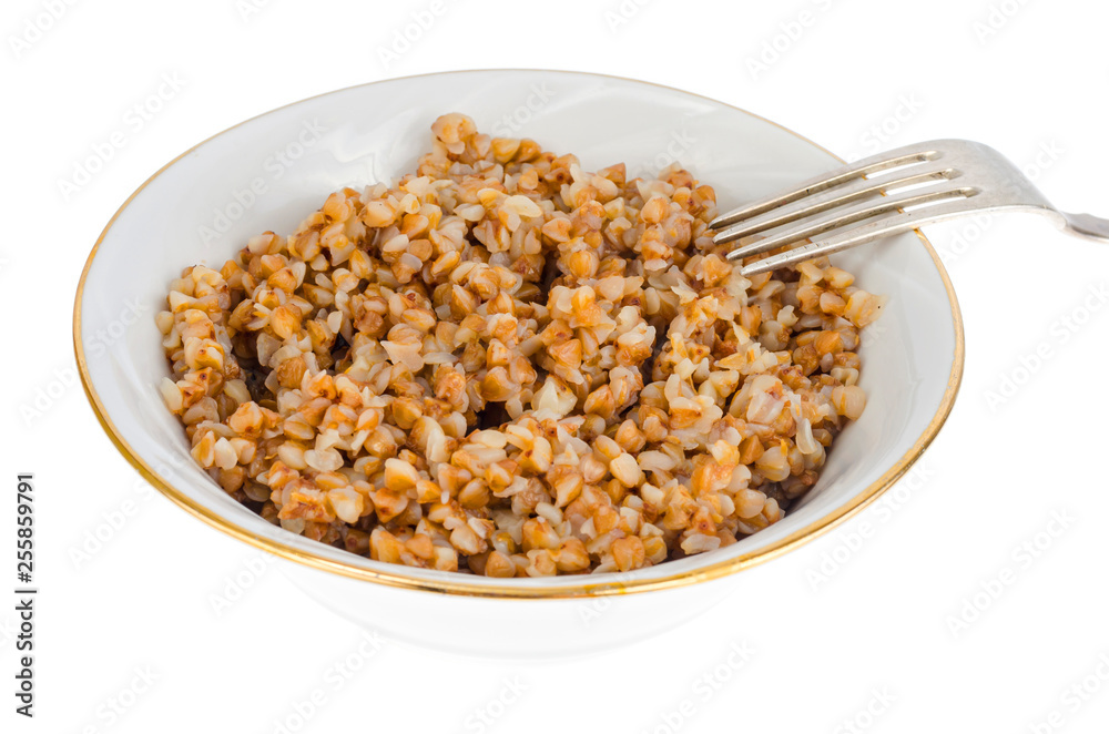 Buckwheat porridge in white plate, vegetarian dish Buckwheat porridge in white plate, vegetarian dish