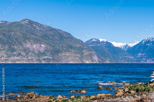 Burrard Inlet, ocean and island with mountains in beautiful British Columbia. Canada.